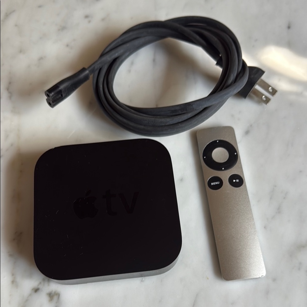 Apple TV Media Streamer with Silver Remote and Black Power Cable